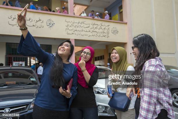 Malaysian voters take a selfie after casting their ballot in a polling station in Kuala Lumpur on May 9, 2018. Malaysians vote on May 9th in highly...