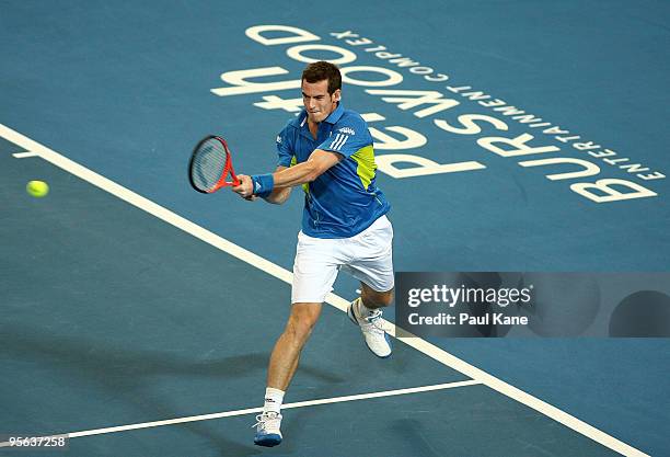 Andy Murray of Great Britain plays a backhand shot in his match against Igor Andreev of Russia in the Group B match between Great Britain and Russia...