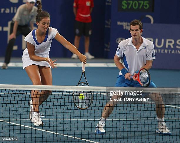Laura Robson and Andy Murray of Britain return a shot against Igor Andreev and Elena Dementieva of Russia during their mixed doubles tennis match on...