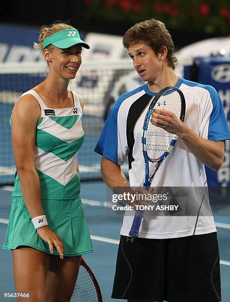 Igor Andreev and Elena Dementieva of Russia discuss tactics during their mixed doubles tennis match against Andy Murray and Laura Robson of Britain...