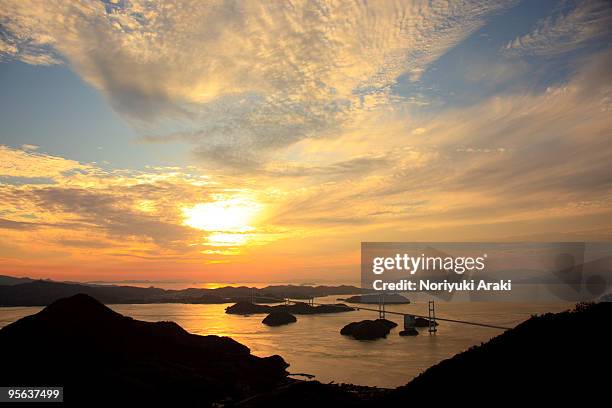 kurushima kaikyo bridge, bridge across sea at sun - imabari city stock pictures, royalty-free photos & images