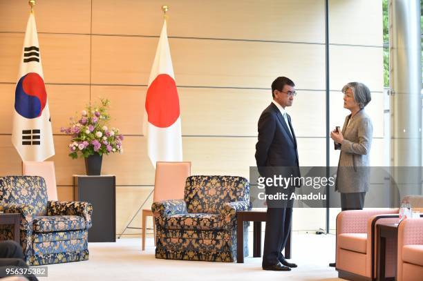South Korea's Foreign Minister Kang Kyung-wha chats with her Japanese counterpart Taro Kono prior to the summit meeting by President Moon Jae-in and...