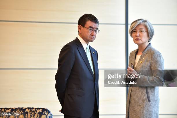 South Korea's Foreign Minister Kang Kyung-wha chats with her Japanese counterpart Taro Kono prior to the summit meeting by President Moon Jae-in and...