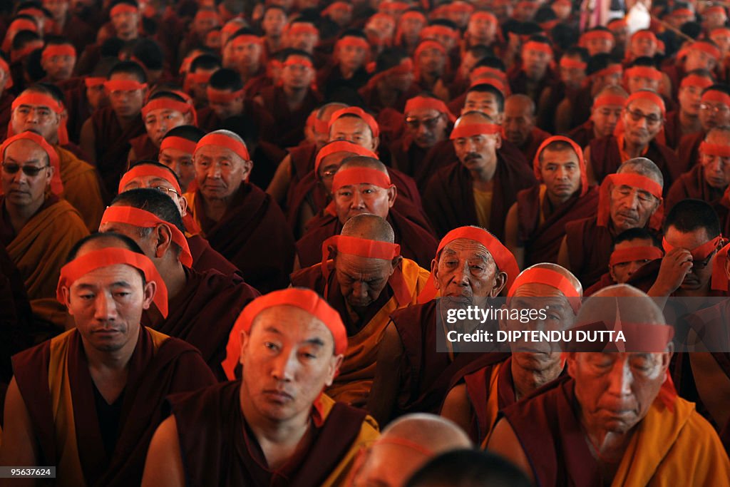 Buddhist monks wear red bandanas during