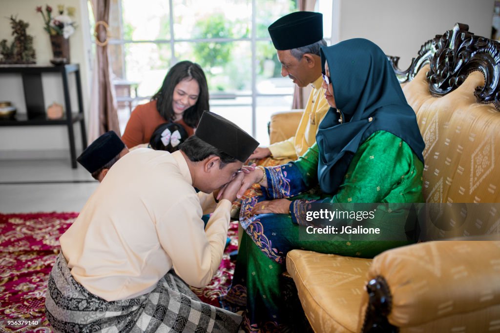 Son asking his mother for forgiveness as part of the the Islamic celebration of Hari Raya Aidilfitri (Eid al-Fitr)