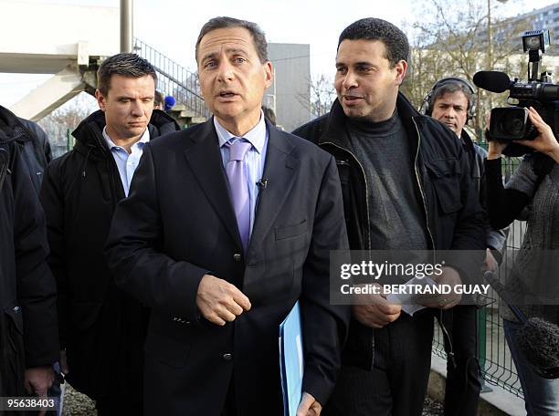 France's minister for immigration and national identity Eric Besson talks with the president of the association "Citoyennete et democratie" Hassan...