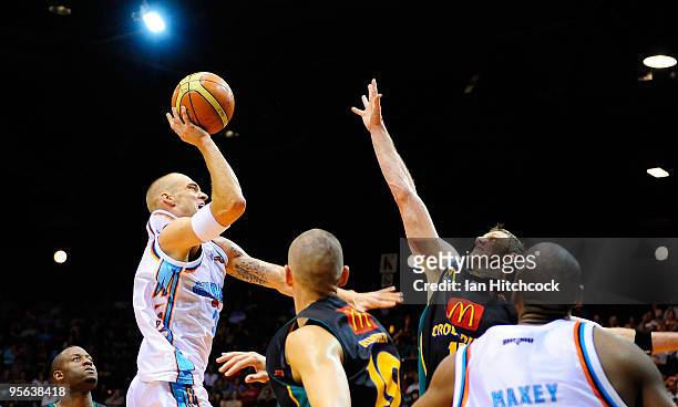 James Harvey of the Blaze makes a jump shot over Peter Crawford of the Crocodiles during the round 15 NBL match between the Townsville Crocodiles and...