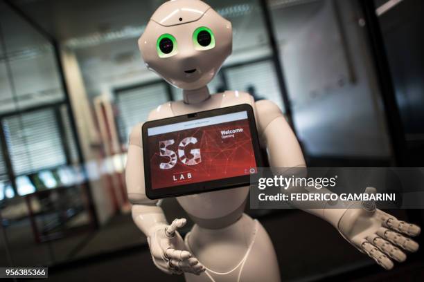 Robot "Pepper" welcomes guests arriving for the opening of the Vodafone 5G Lab in Duesseldorf, western Germany, on May 9, 2018. - At the lab, all...