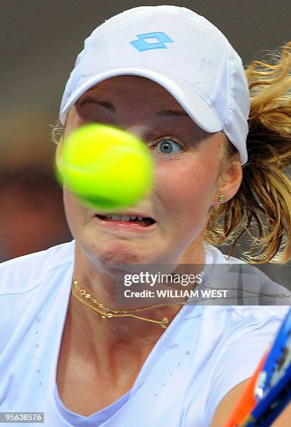 Ekaterina Makarova of Russia keeps her eye on the ball during her loss to Alicia Molik of Australia in the first round of the Brisbane International...