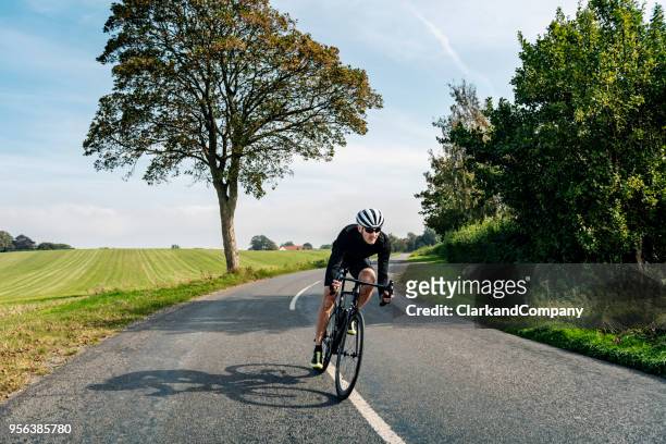 cyclist out on a training ride - country road stock pictures, royalty-free photos & images