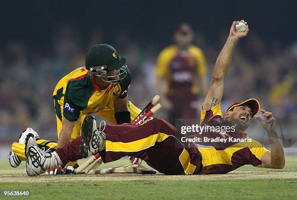 Lee Carseldine of the Bulls runs out Tim Paine of the Tigers during the Twenty20 Big Bash match between the Queensland Bulls and the Tasmanian Tigers...