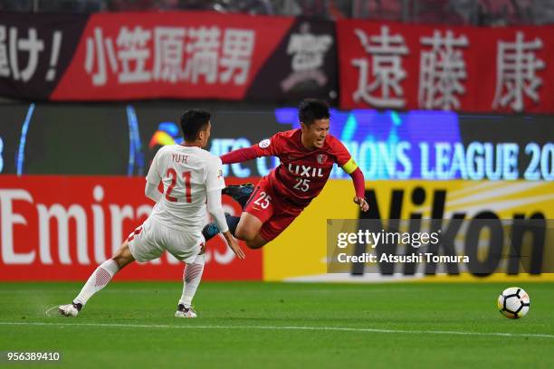 Yasushi Endo of Kashima Antlers is challenged by Yu Hai of Shanghai SIPG during the AFC Champions League Round of 16 first leg match between Kashima...