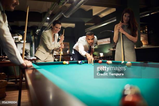 playing pool after a hard work day. business retreats. - work hard play hard stock pictures, royalty-free photos & images
