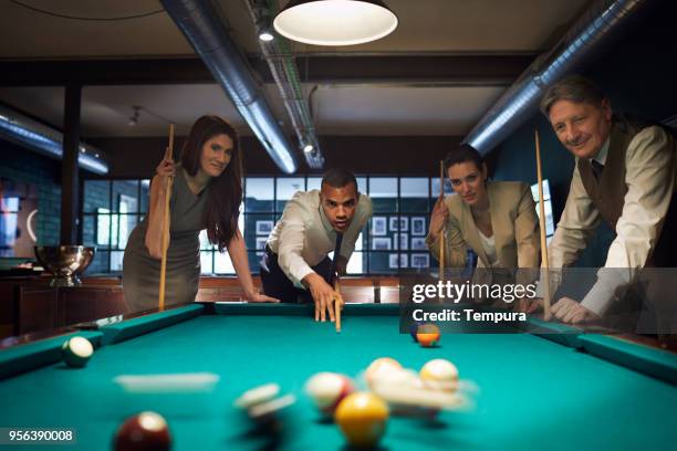 playing pool after a hard work day. business retreats. - work hard play hard stock pictures, royalty-free photos & images