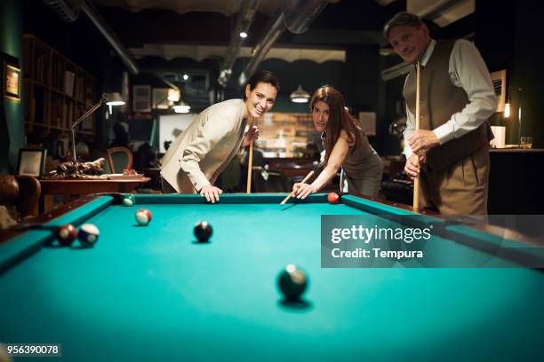 playing pool after a hard work day. business retreats. - work hard play hard stock pictures, royalty-free photos & images