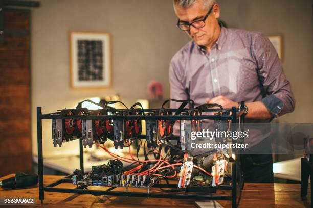 senior working on mining rig - rigips stock pictures, royalty-free photos & images