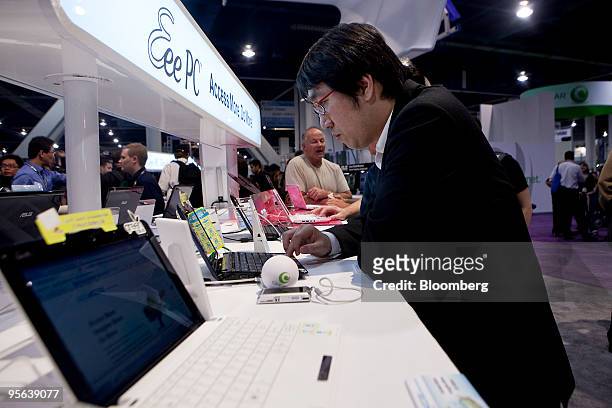 An attendee tries out an Asustek Computer Inc. Eee PC netbook during the 2010 International Consumer Electronics Show in Las Vegas, Nevada, U.S., on...