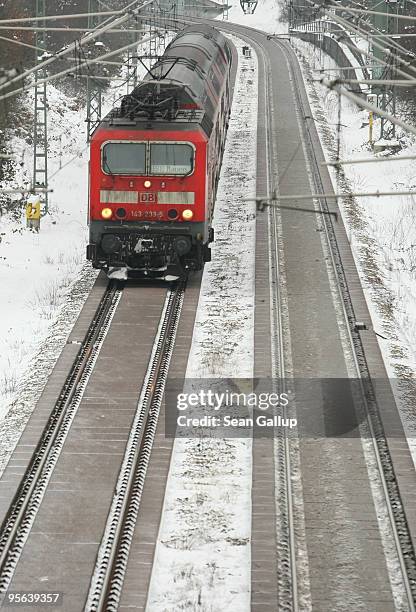 Passenger train makes its was through a snow-covered suburb on January 8, 2010 in Berlin, Germany. Up to 40cm of new snow is predicted for Germany...