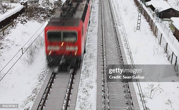 Passenger train makes its was through a snow-covered suburb on January 8, 2010 in Berlin, Germany. Up to 40cm of new snow is predicted for Germany...