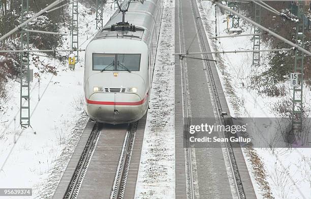 High-speed ICE train makes its was through a snow-covered suburb on January 8, 2010 in Berlin, Germany. Up to 40cm of new snow is predicted for...