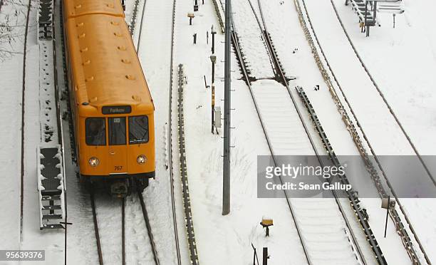 An U-Bahn commuter metro train makes its was through a snow-covered suburb on January 8, 2010 in Berlin, Germany. Up to 40cm of new snow is predicted...