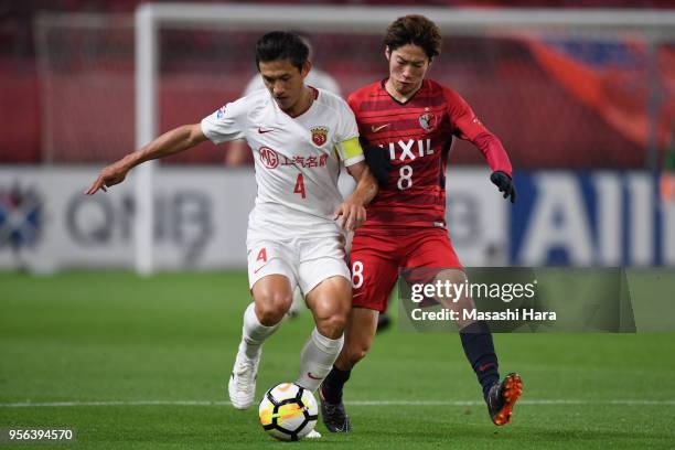 Wang Shenchao of Shanghai SIPG and Shoma Doi of Kashima Antlers compete for the ball during the AFC Champions League Round of 16 first leg match...