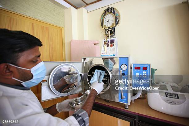 Dentist Dr. Arun sterilizes dental instruments in his dental spa clinic at Clafouti hotel in Varkala on December 22, 2009 in Varkala near Trivandrum,...