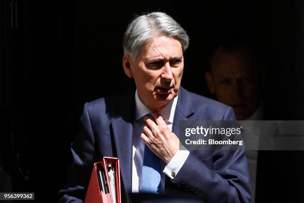 Philip Hammond, U.K. Chancellor of the exchequer, leaves Downing Street to attend a weekly questions and answers session in Parliament in London,...