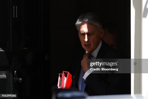 Philip Hammond, U.K. Chancellor of the exchequer, leaves Downing Street to attend a weekly questions and answers session in Parliament in London,...