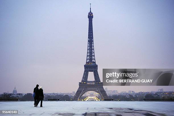 People walk on the snow-covered Trocadero esplanade near the Eiffel Tower on January 7, 2010 in Paris, as Europe shivered in bitterly cold...