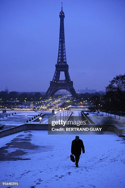 Man walks on the snow-covered Trocadero esplanade on January 7, 2010 near the Eiffel Tower in Paris, as Europe shivered in bitterly cold temperatures...