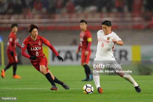 Cai Huikang of Shanghai SIPG takes on Shoma Doi of Kashima Antlers during the AFC Champions League Round of 16 first leg match between Kashima...