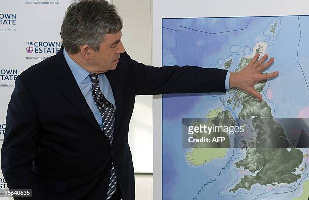 British Prime Minister Gordon Brown stands with a map of the plans for a new initiative to build off-shore wind farms ahead of a press conference at...