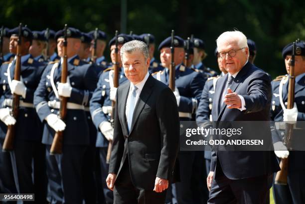 German President Frank-Walter Steinmeier and his Colombian counterpart Juan Manuel Santos inspect a military honor guard during a welciming ceremony...