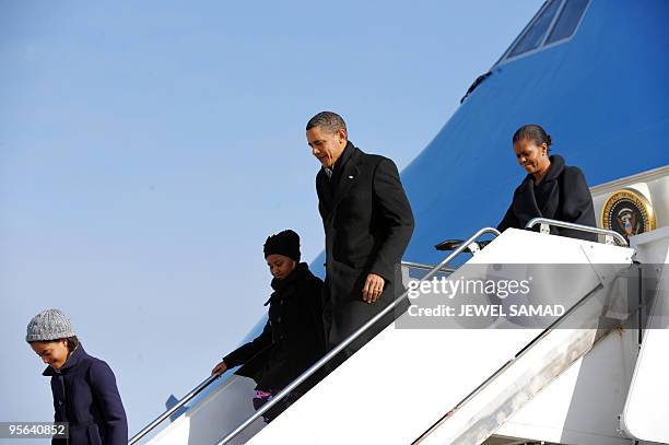 President Barack Obama, First Lady Michelle Obama and their daughters Malia and Sasha disembark from Air Force One at Andrews Air Force Base in...