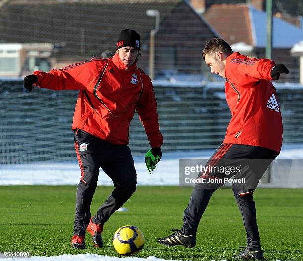 Alberto Aquilani takes on Fabio Aurelio as they takes part in a Liverpool FC team training session at the club's Melwood training ground on January...
