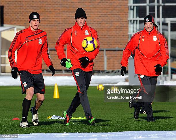 Fernando Torres in the middle of Daniel Agger and Albert Riera as they take part in a Liverpool FC team training session at the club's Melwood...