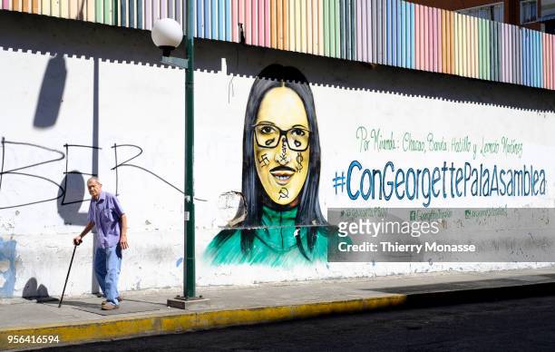 Political painted wall of Georgette Topalian a Pro-Maduro politician. Her face was tagged with a Svastika, an US $ and a Communist Symbol .