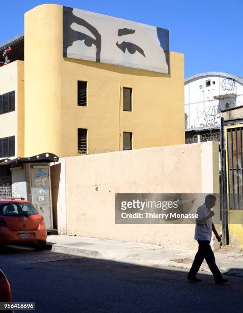 Chavez's eyes on the "Corporacion Socialista del Cemento, S.A." building. Maduro's government sits over a historical, affective and iconic image of...