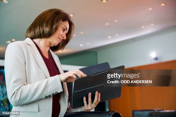 German Justice Minister Katarina Barley reads a brief at the start of the weekly cabinet meeting at the Chancellery in Berlin on May 9, 2018.