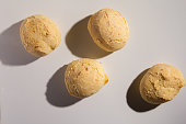 Pao de Queijo is a cheese bread ball from Brazil. Also known as Chipa, Pandebono and Pan de Yuca. Snacks over white background, minimalism.