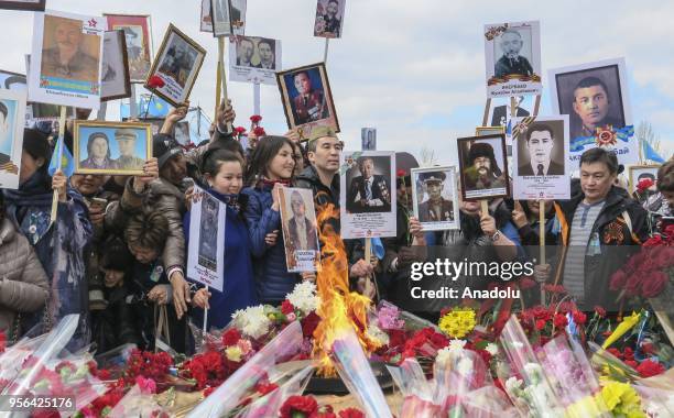 People attend the military parade during Victory Day marking the 73rd anniversary of the Soviet Union's victory over Nazi Germany in the 1941-1945...