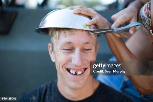 woman cutting young mans hair using bowl, mans teeth blacked out - white teeth stock pictures, royalty-free photos & images