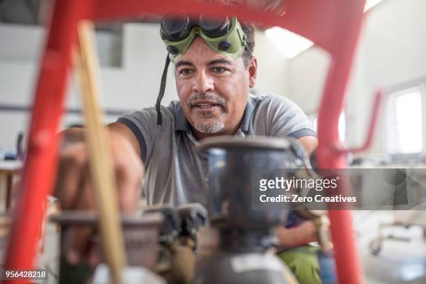 man preparing welding jig in bodywork repair shop - bodywork stock pictures, royalty-free photos & images