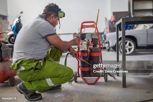 man preparing welding jig in bodywork repair shop - bodywork stock pictures, royalty-free photos & images