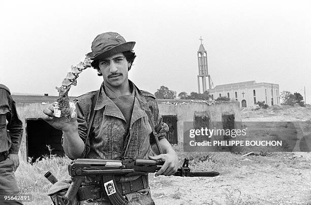 Militiaman from Amal movement displays 09 May 1985 in the Christian village of Jiyeh, near Saida a vertebra column taken from mass burial pit. In May...