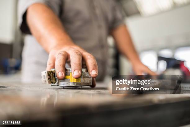 cropped view of man sanding in bodywork repair shop - bodywork stock pictures, royalty-free photos & images