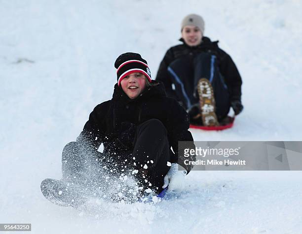 Year olds Conor Hewitt and Jamea Wales sledding on Devil's Dyke on January 8, 2010 in Brighton, United Kingdom. Extremely cold conditions are...