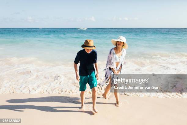 mother and son walking on beach - dominican republic stock pictures, royalty-free photos & images