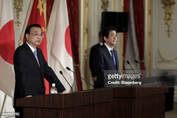 Li Keqiang, China's premier, left, speaks while Shinzo Abe, Japan's prime minister, looks on during a joint news conference following a bilateral...